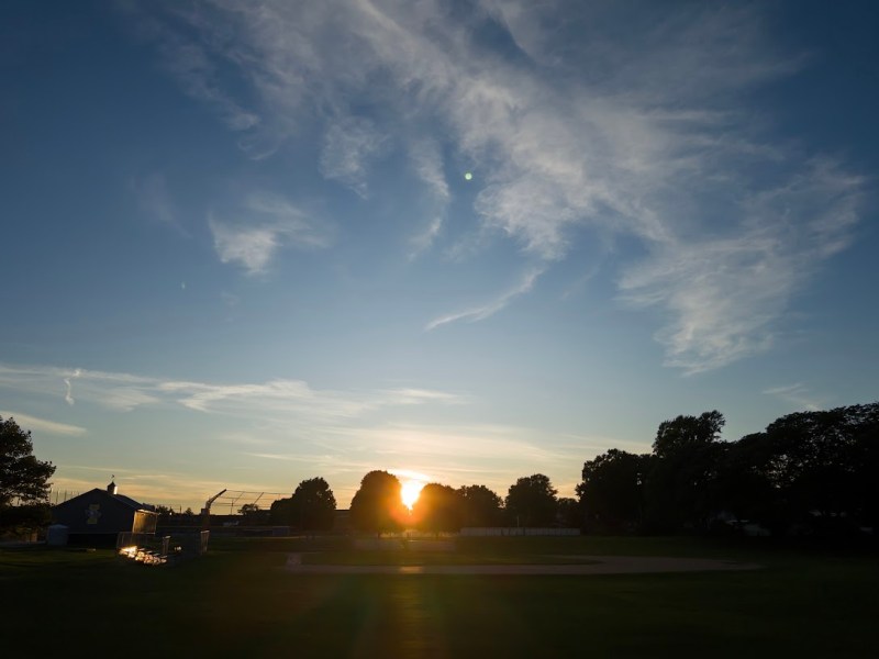 a high school baseball field at&nbsp;sunset